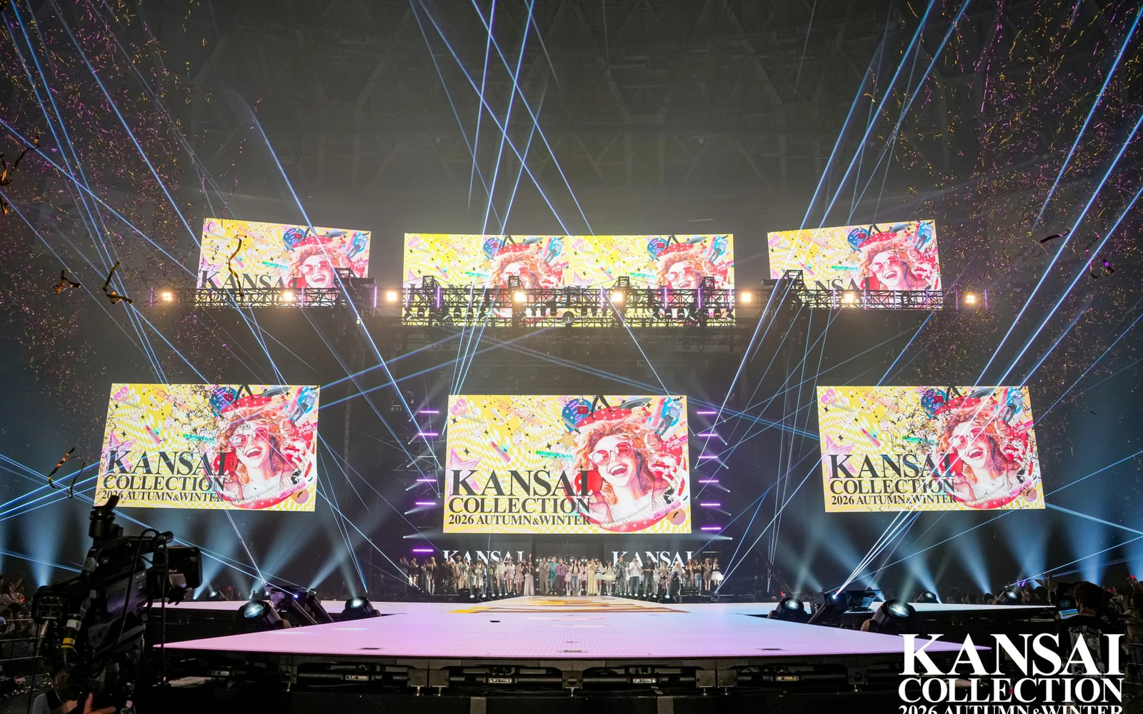 Kansai Collection finale at Kyocera Dome Osaka, runway lit under six LED surfaces carrying the show artwork